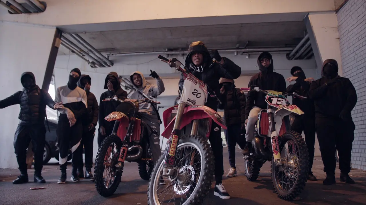 Riders with motocross bikes gathered in an underground car park