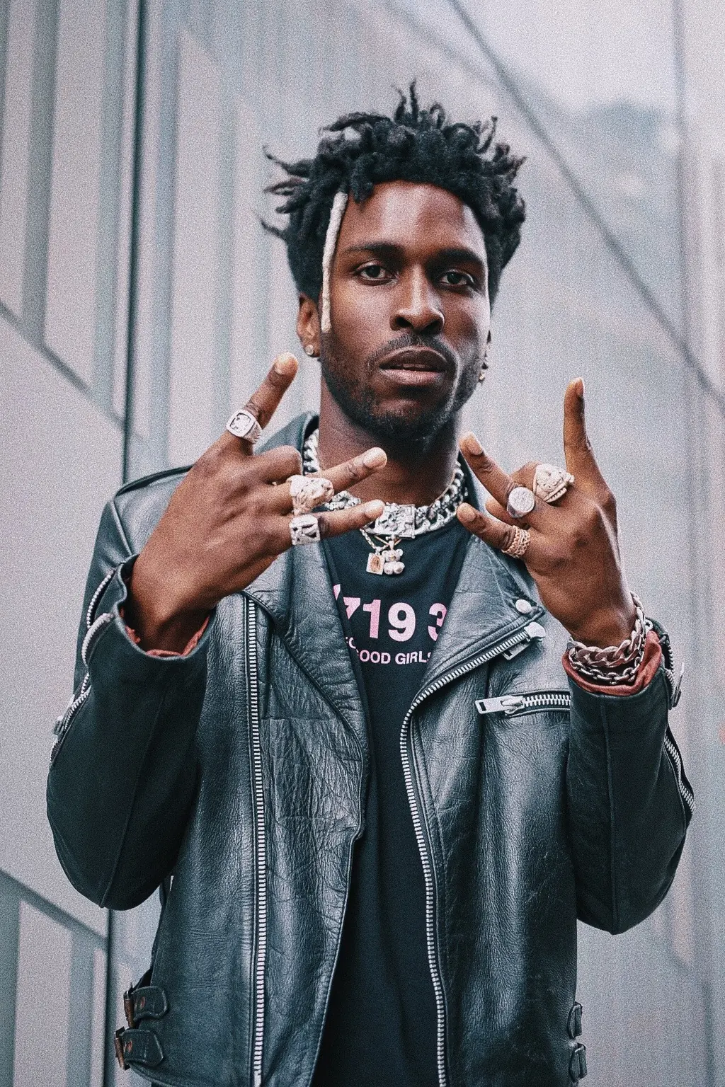 Artist in a leather jacket with rings