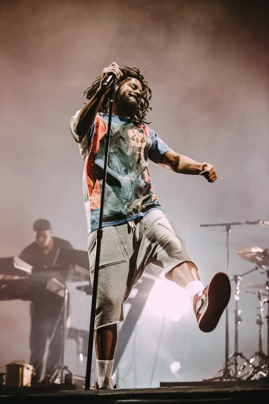 Performer mid-song on a festival stage
