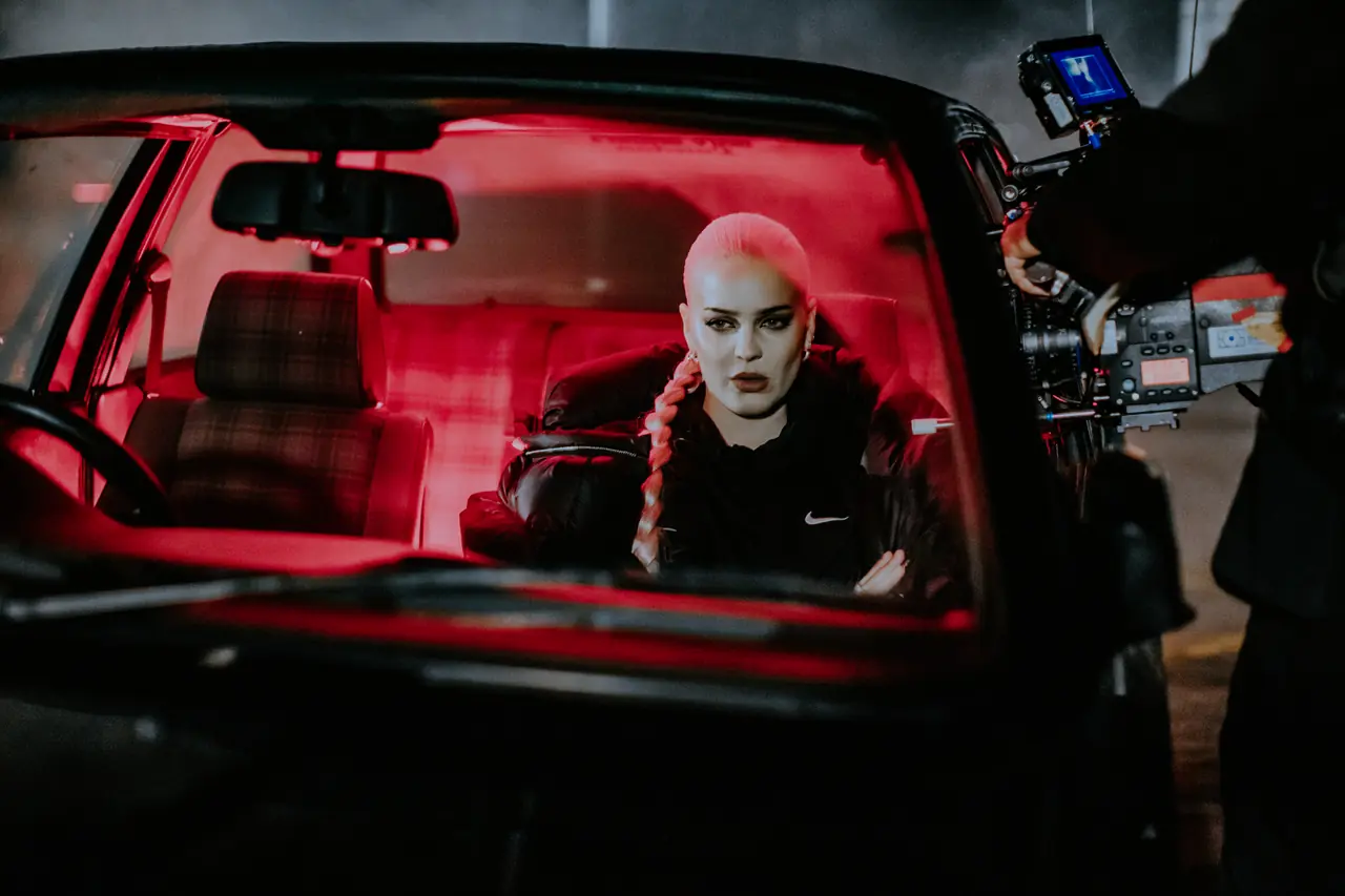Music video set, red-lit car